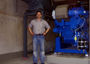 BHKW-Package 770 kW, Tag der Einbringung. 
Dieses Foto entstand gegen 23:00 Uhr mit Selbstauslöser am Tag der Einbringung des 16-Zylinder-Gen-Sets. Ich war Planer, Einkäufer, Bauleiter und Projektverantwortlicher für das Projekt und seit 5:00 Uhr auf der Baustelle.